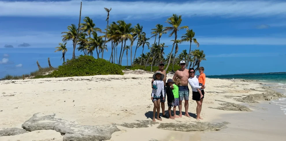 Family on a tiny palm-dotted sandbar island near Nassau, Bahamas