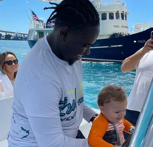 Family with a toddler in a life vest aboard a private charter boat in Nassau Harbour, Bahamas