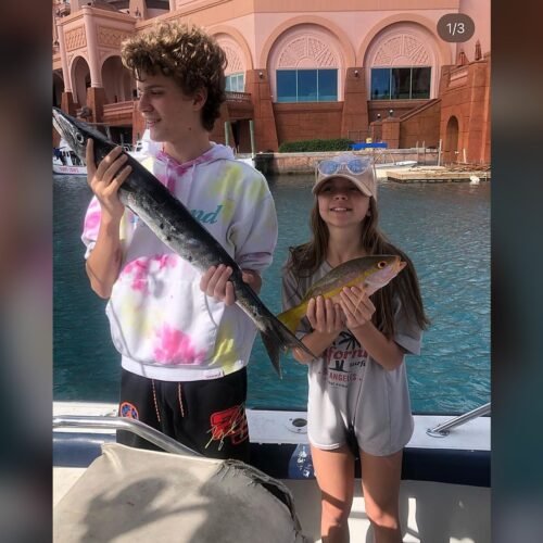 Kids showing off the fish they caught on a Reel Adventure Tours charter