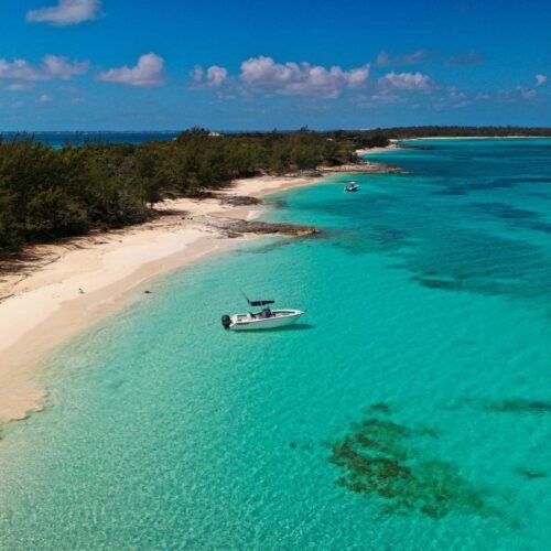 Aerial view of Rose Island’s white sand beach and turquoise shallows