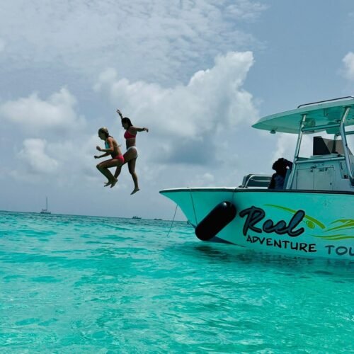 Guest jumping off the Reel Adventure Tours boat into turquoise water