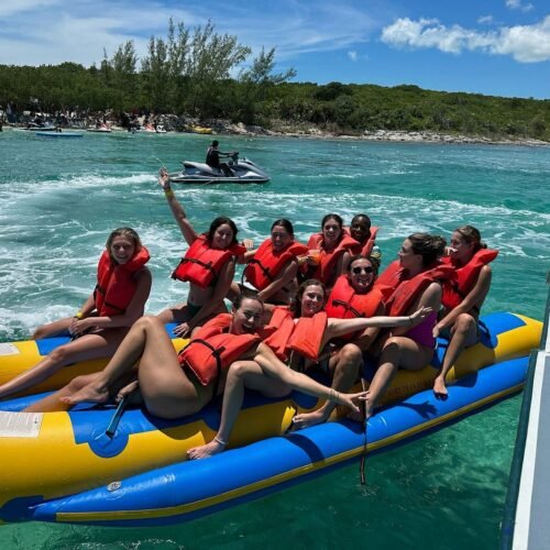 Guests riding a banana boat on a private island tour in the Bahamas